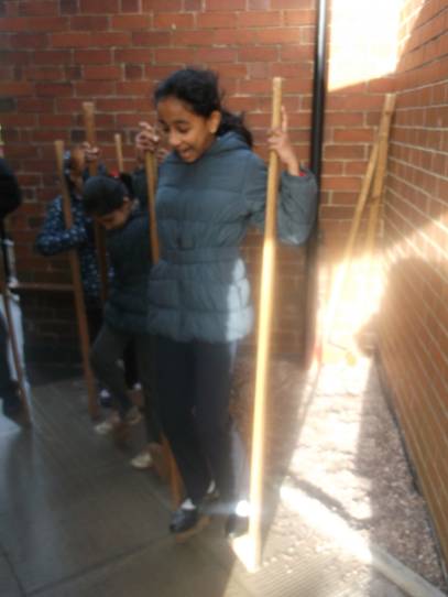 Josna trying out the stilts.